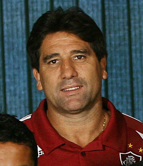 Renato Gaúcho wearing a Fluminense polo shirt, looking at the camera with a neutral expression.