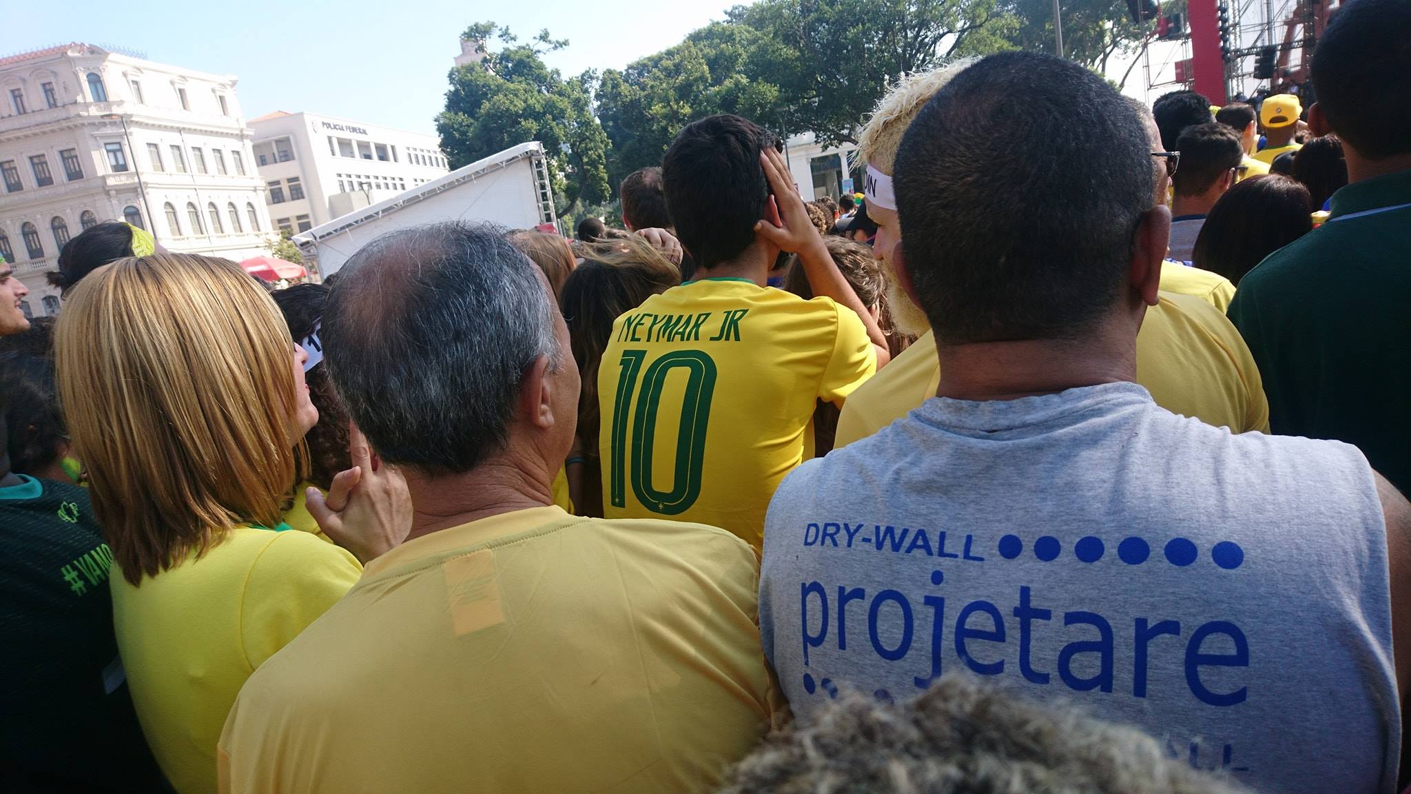 Brazil fans watching a World Cup match in a crowd, with one supporter wearing a Neymar Jr. number 10 shirt.